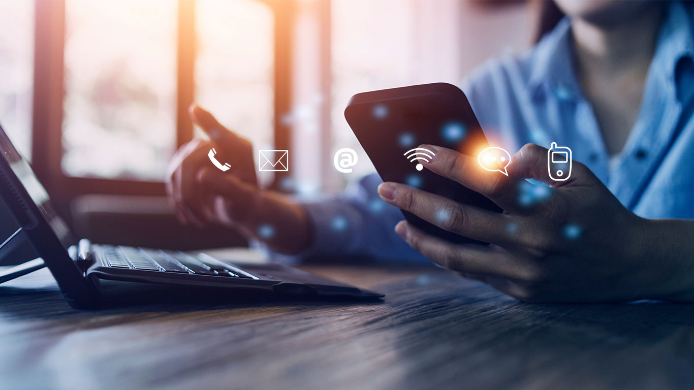 Man on computer and phone